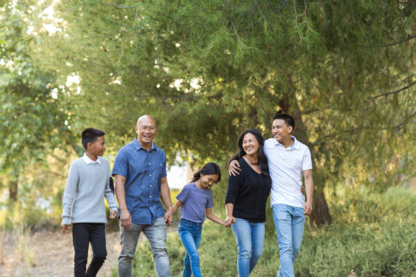 Asian family taking a walk outside and talking.